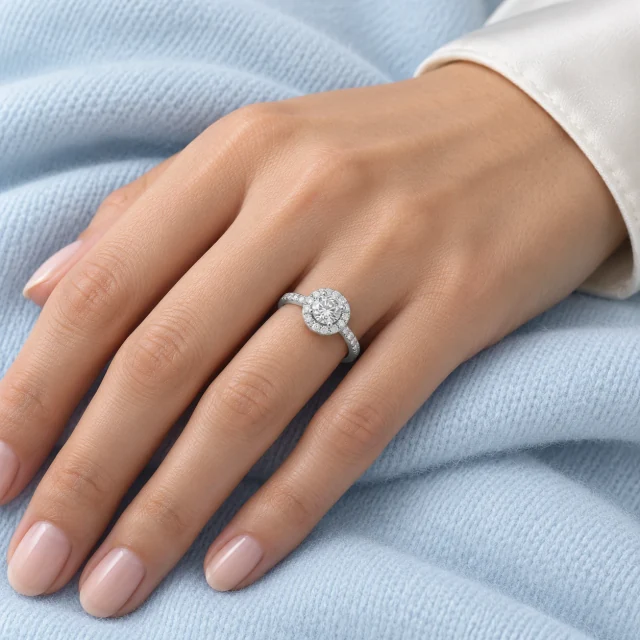 Jennifer Solitario Pavé worn on the ring finger against pale blue fabric