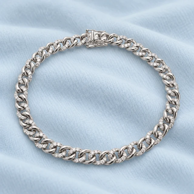 Liaison White-Gold Bracelet on softly folded pale ice-blue cashmere