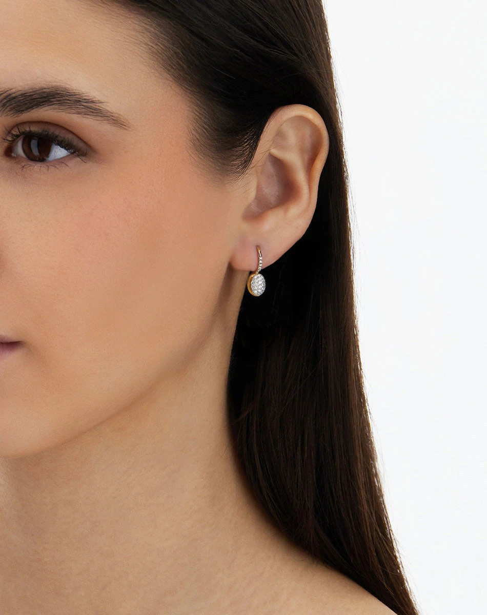 Nanis Ciliegine Baby diamond earrings worn in a close-up portrait